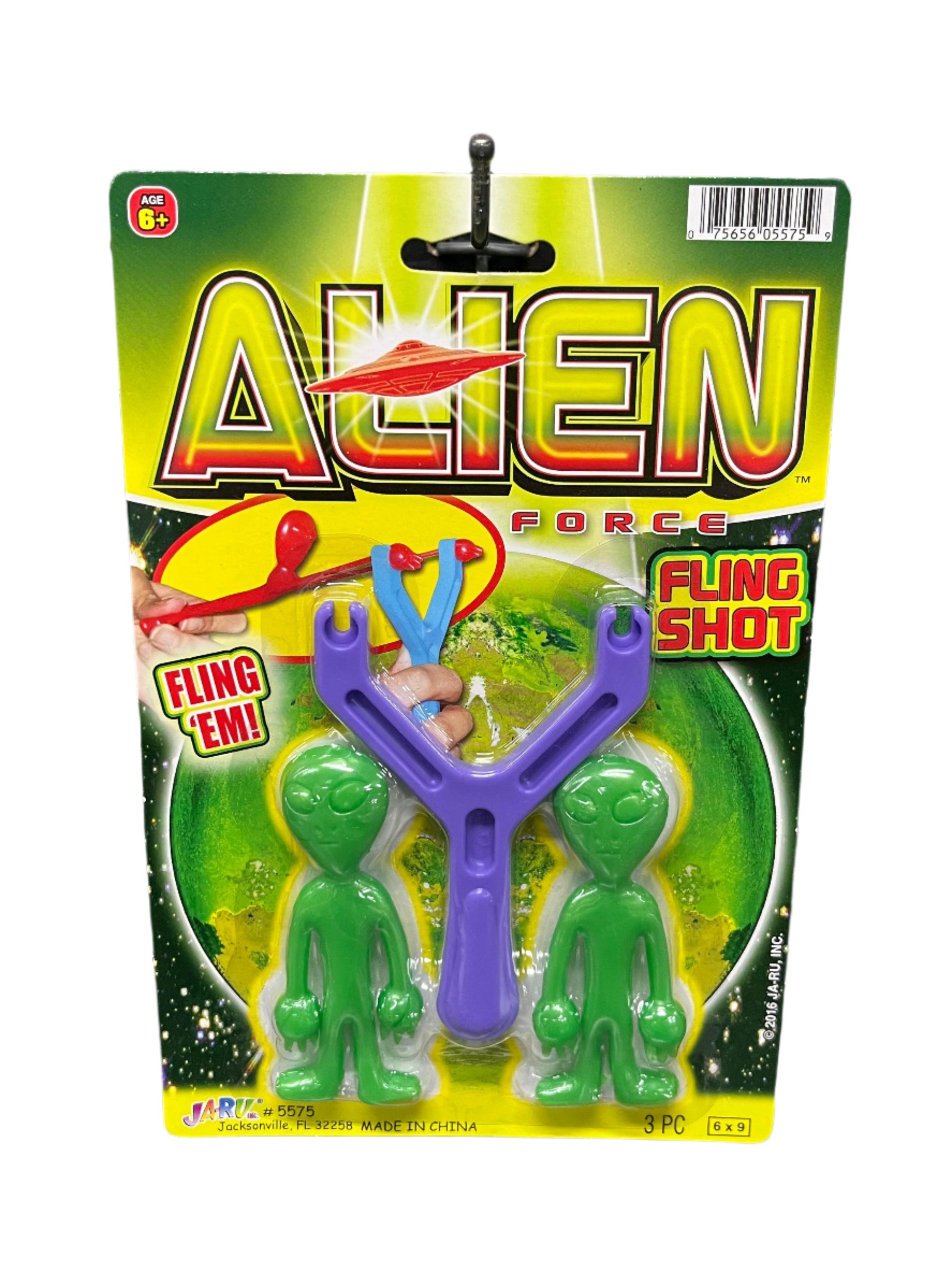 Toy fling shot with green figures on a colorful package labeled 'Alien Force' 